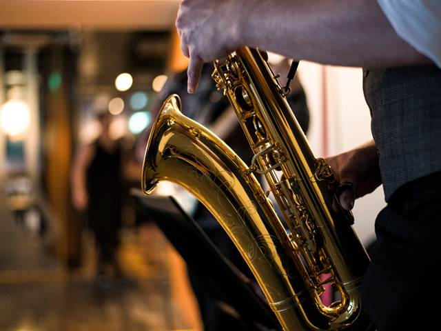 Focused-shot of saxophone from a string quartet band welcoming guests to The Clydeside Distillery