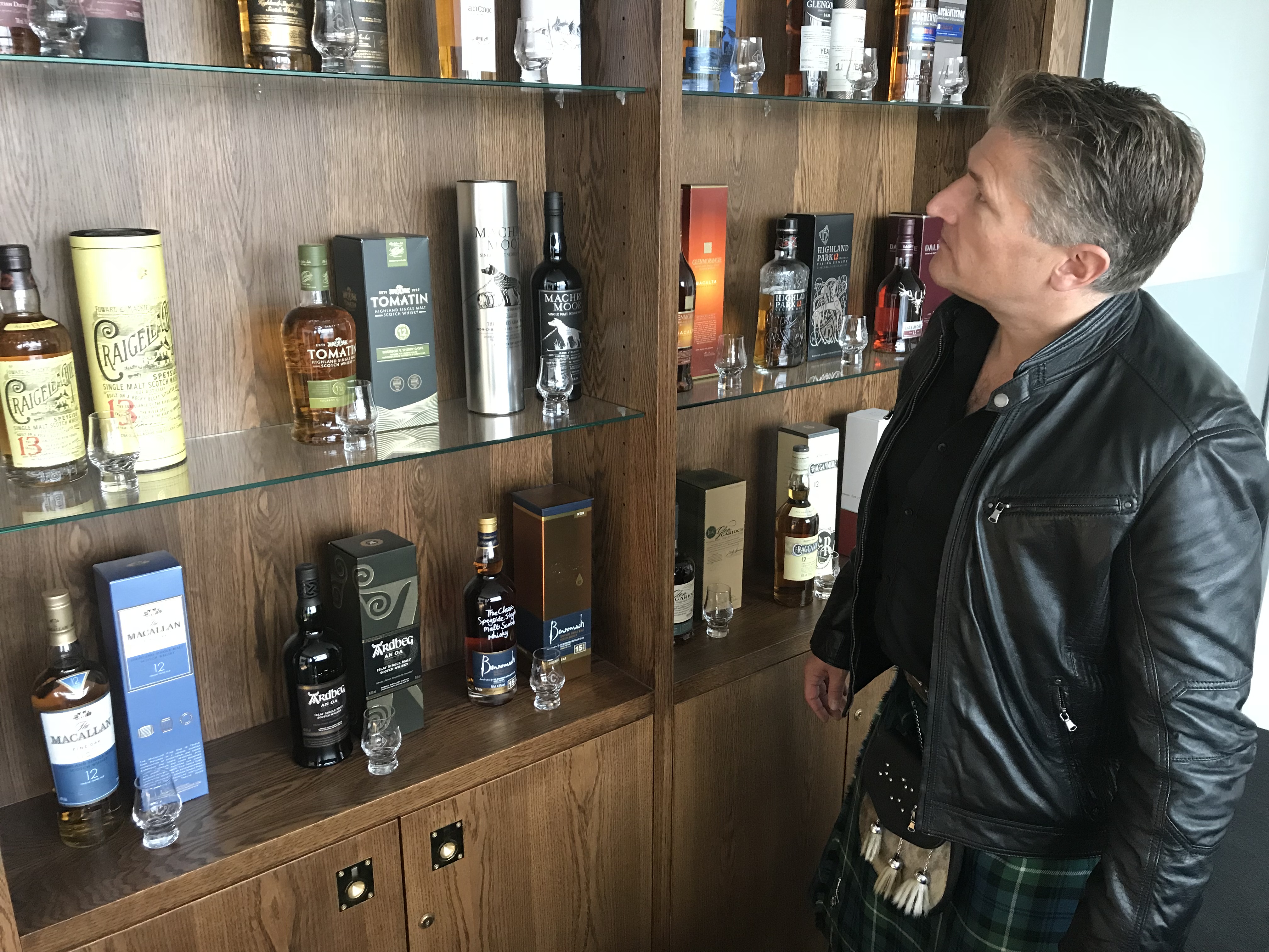 a man exploring a whisky selection