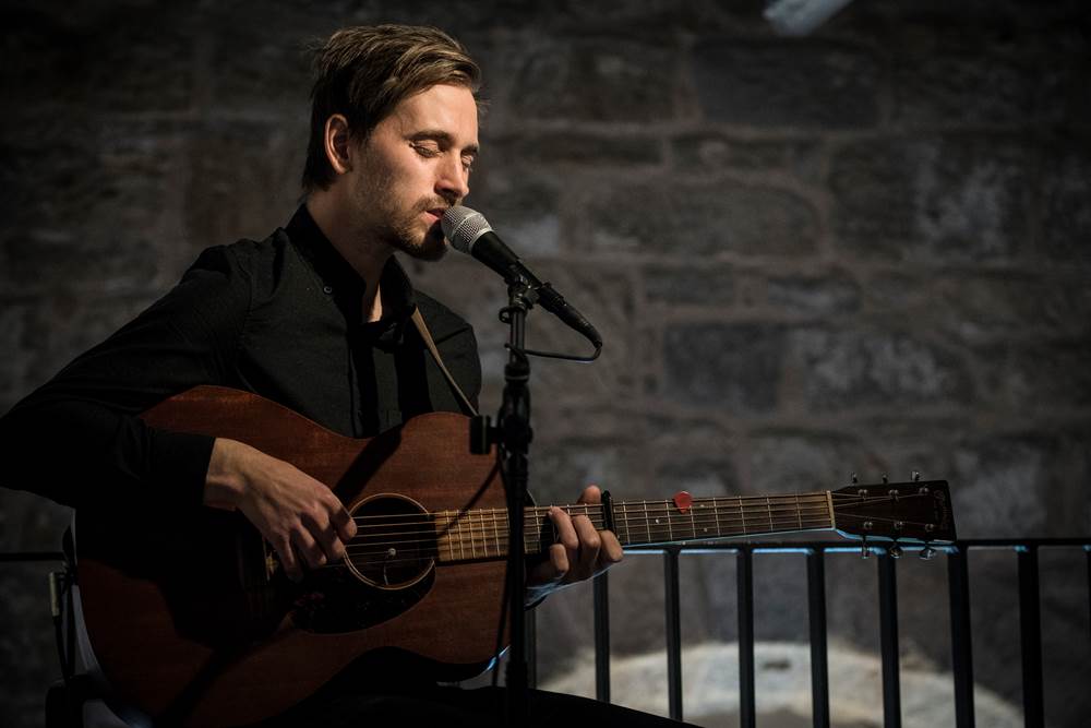 Acoustic singer with guitar playing at The Clydeside Distillery