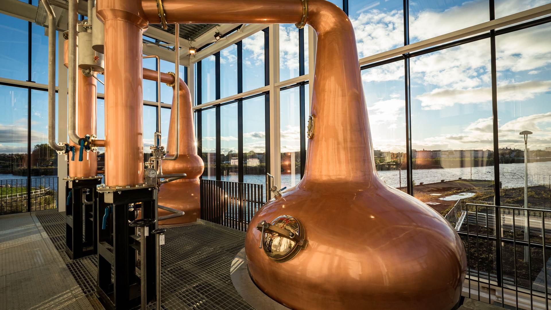 Two Clydeside Copper Stills with blue sky background