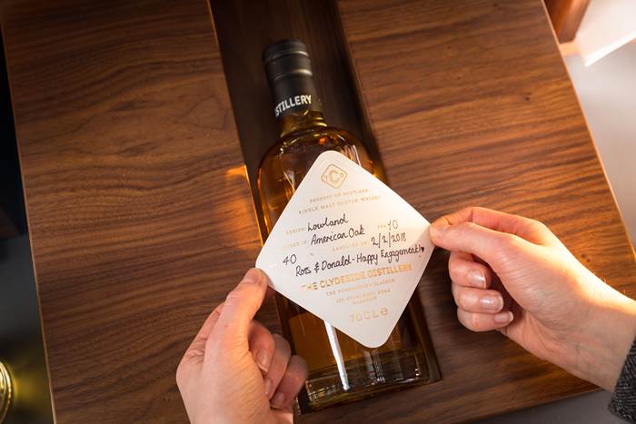 Labelling a bottle from the Label Your Own range at The Clydeside Distillery