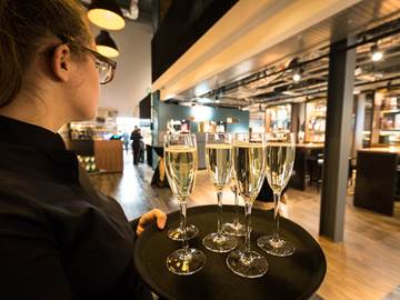Waiter holding tray of champagne flutes for a private event at The Clydeside Distillery