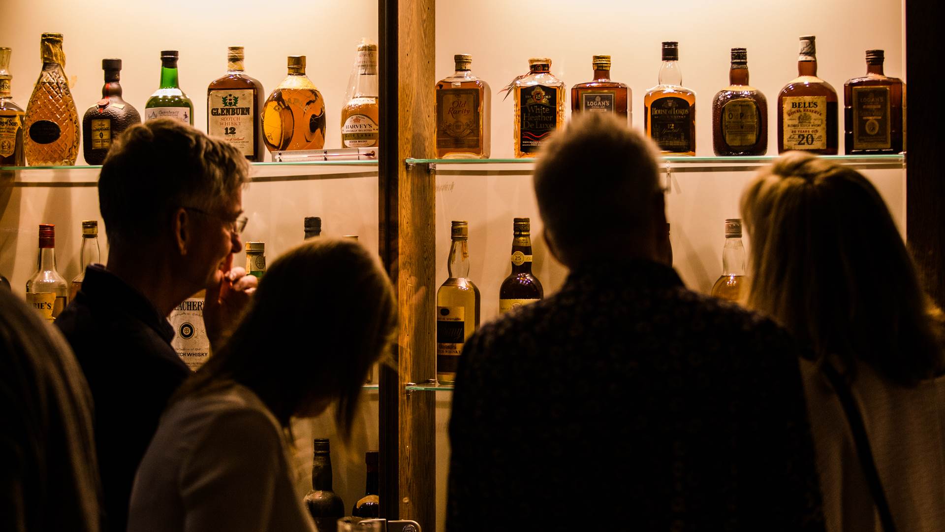 Group of guests observing whisky collection at The Clydeside Distillery
